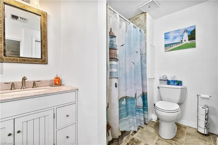 Bathroom featuring tile flooring, oversized vanity, and toilet