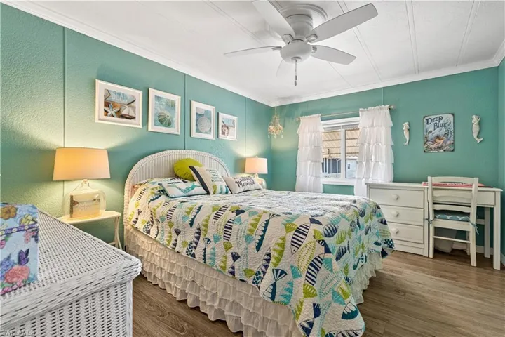 Bedroom featuring ornamental molding, ceiling fan, and hardwood / wood-style floors