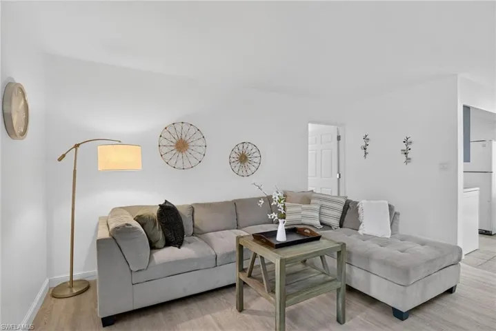 Living area with light wood-style floors and baseboards
