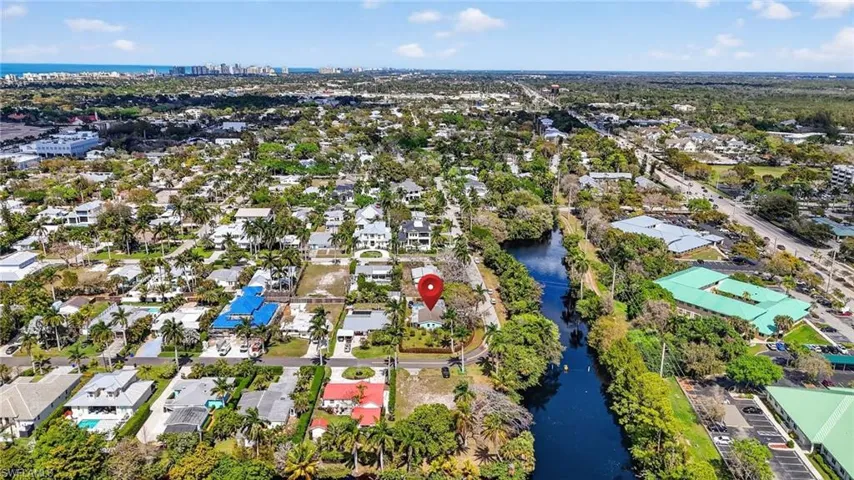 Aerial perspective of suburban area featuring a large body of water