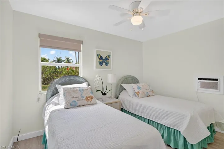 Bedroom 2 with ceiling fan and wood finished floors