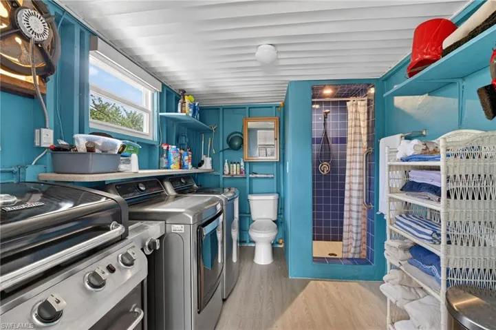 Laundry area off the sunroom with shower, toilet and washer/ dryer
