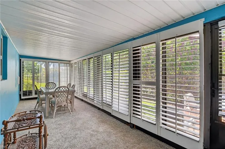 Sunroom / solarium featuring carpet floors and healthy amount of natural light