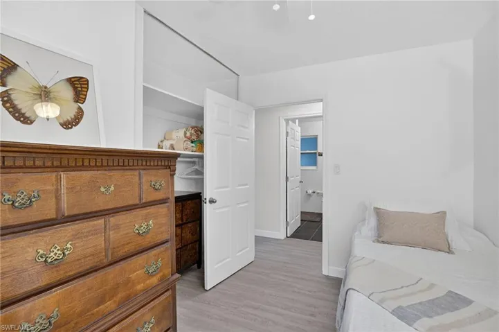 Bedroom 3 with light wood finished floors and a ceiling fan