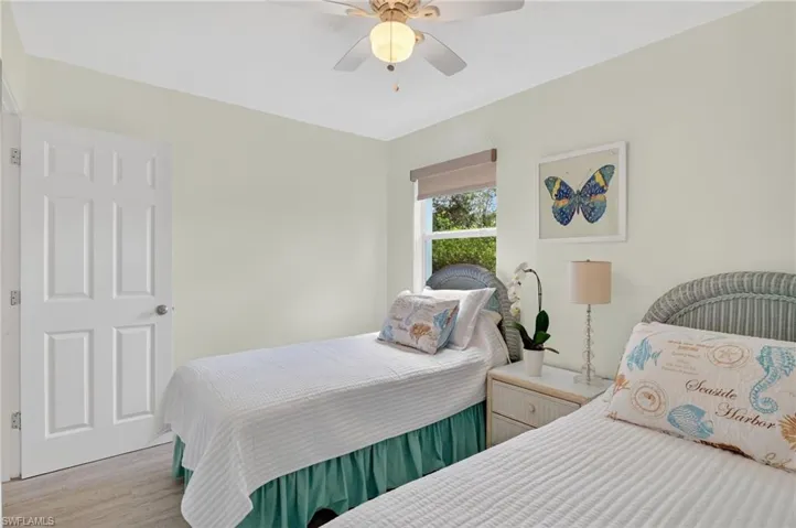 Bedroom 2 with ceiling fan and light wood finished floors