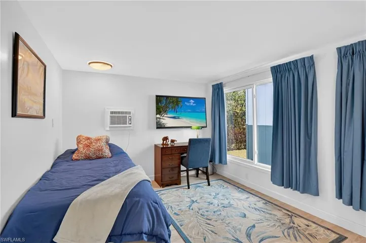Bedroom 4 with baseboards and wood finished floors