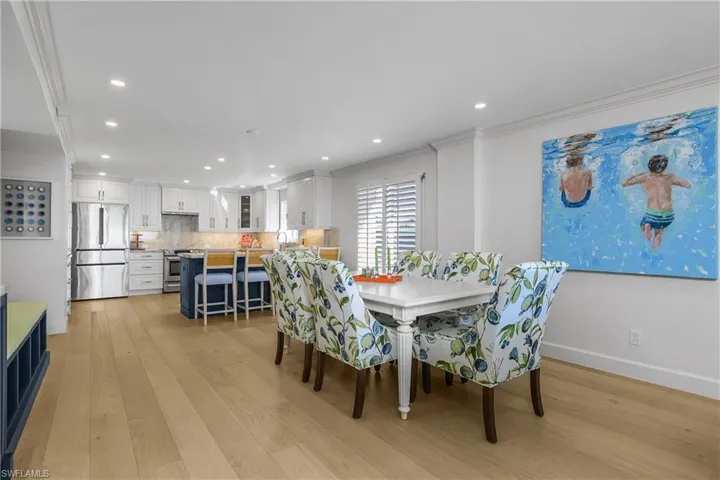 Dining space with Custom cabinetry and flooring, recessed lighting, and crown molding