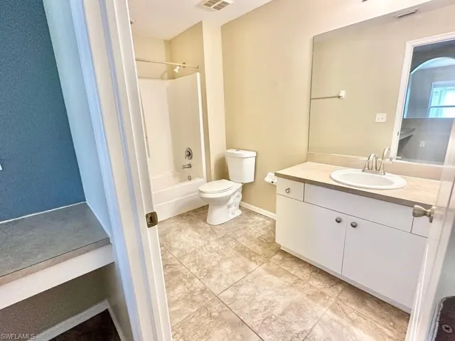 Full bath featuring vanity and shower / washtub combination