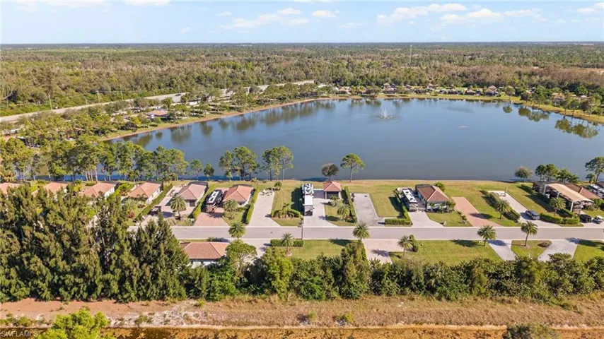 Birds eye view of property with a water view