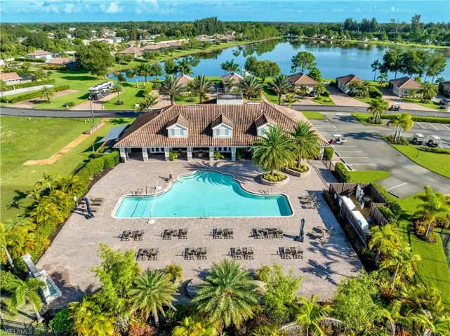 Birds eye view of property with a water view