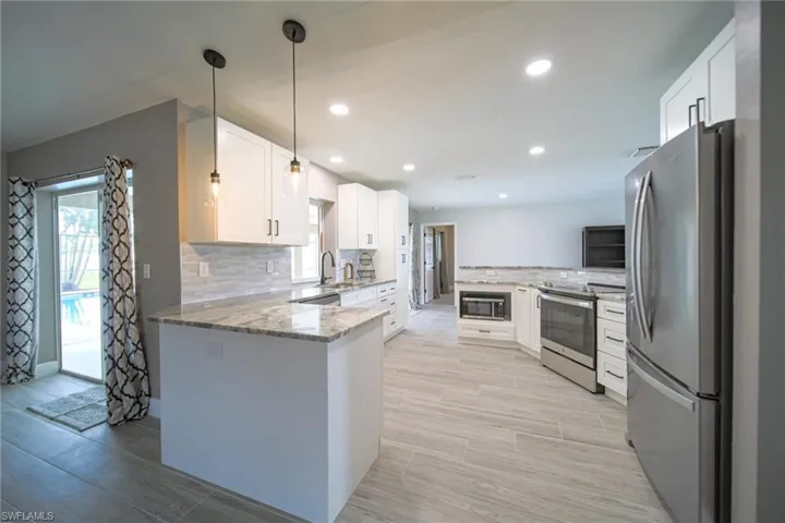 The Kitchen Has New Cabinets, Granite Countertops, Tile Backsplash, Stainless Steel Appliances, And New Pendant Lights!