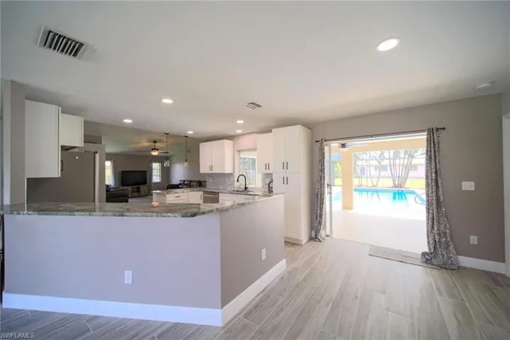 Breakfast Bar With Double Slider Out To Covered Lanai And Screened Pool Area!