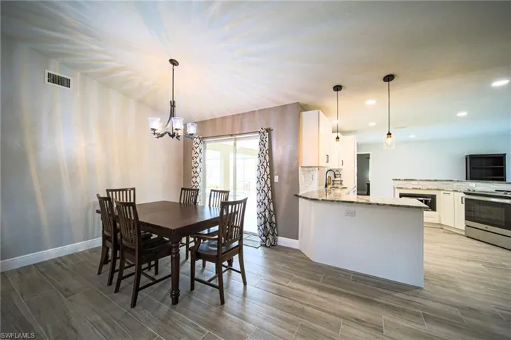 Formal Dining Area With A Double Slider Leading Out To A Covered Lanai And Screened Pool Area!