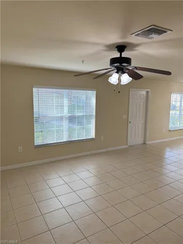 Tiled empty room with ceiling fan