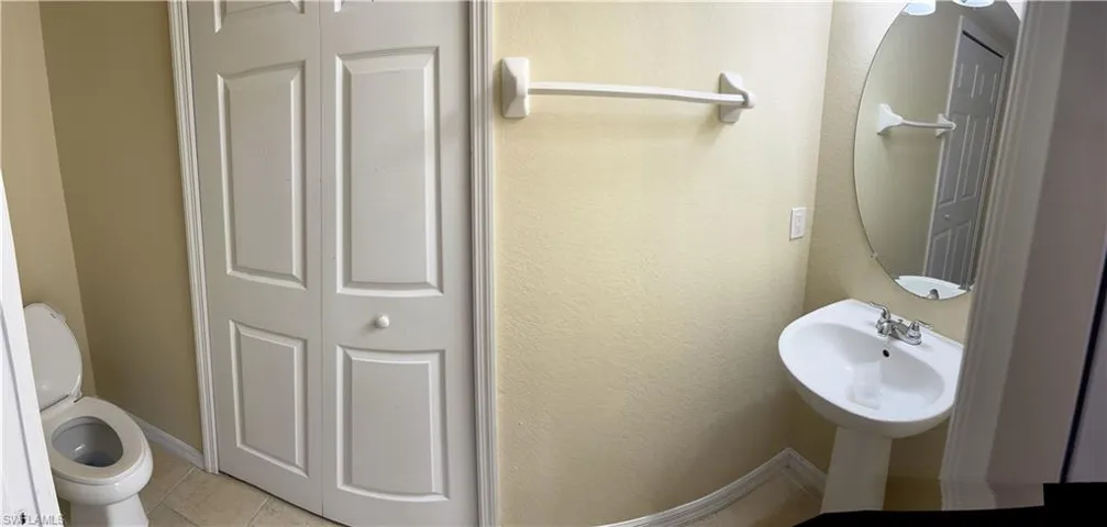 Bathroom featuring toilet and tile patterned flooring