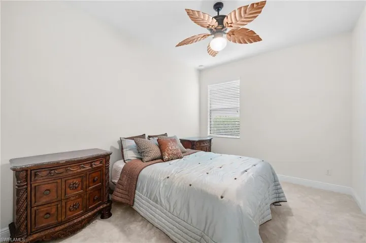 Bedroom featuring ceiling fan and light carpet