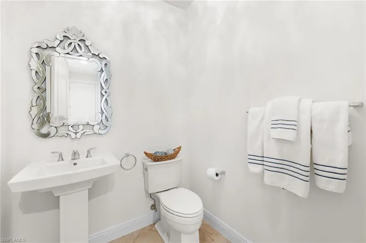 Bathroom with tile patterned floors, toilet, and sink