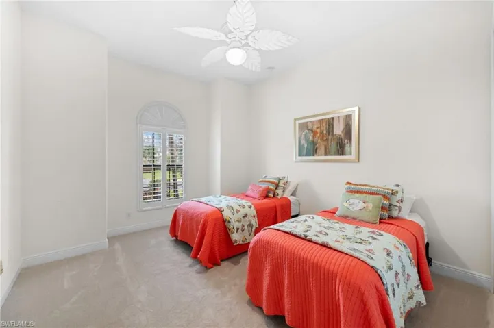 Carpeted bedroom with ceiling fan