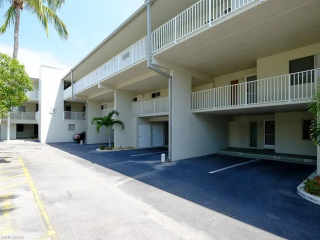 View of building exterior with covered parking