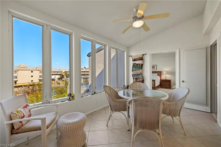 Sunroom / solarium featuring vaulted ceiling and tile patterned flooring