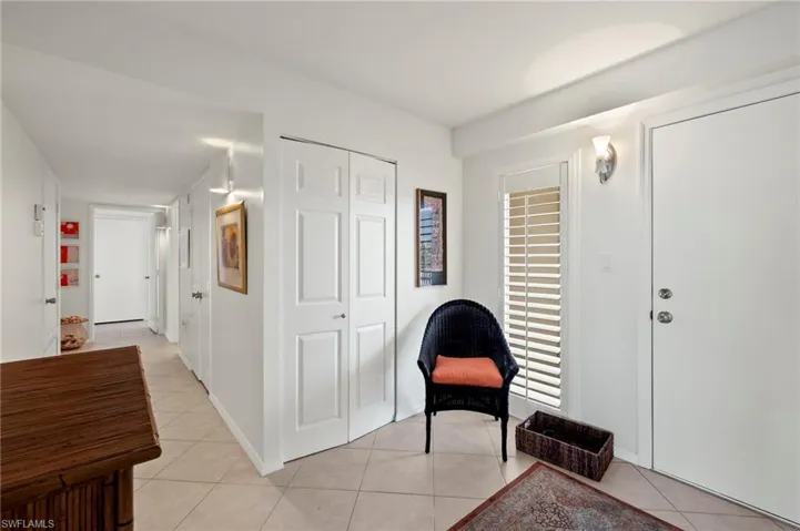 Living area with light tile patterned floors and baseboards