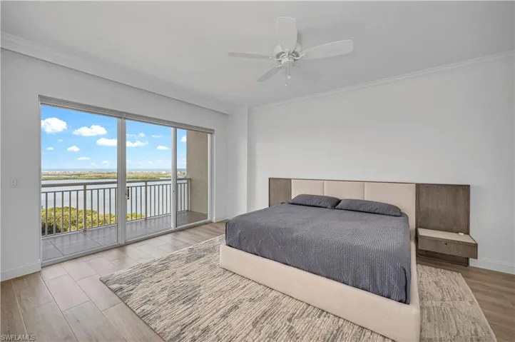 Bedroom 1 featuring ceiling fan, ornamental molding, light hardwood / wood-style floors, and access to outside