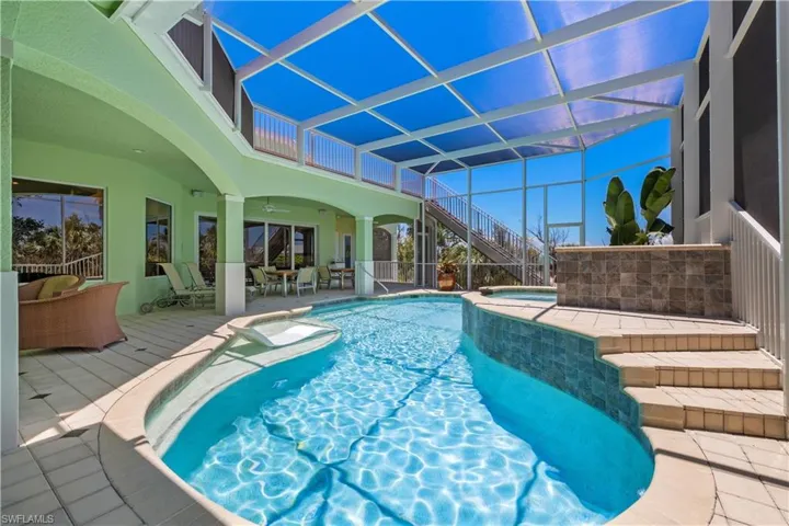 View of swimming pool with an in ground hot tub, a patio area, a lanai, and ceiling fan