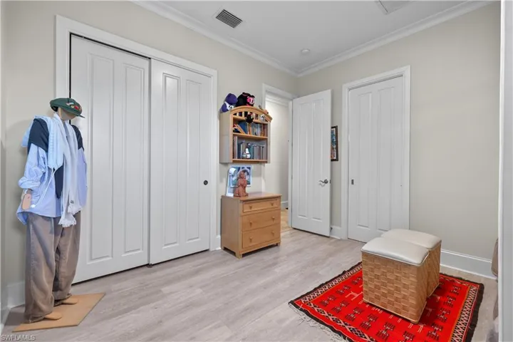 Sitting room featuring ornamental molding and light hardwood / wood-style flooring