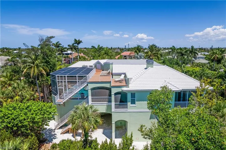 View of front of house featuring a patio area, a lanai, and a balcony