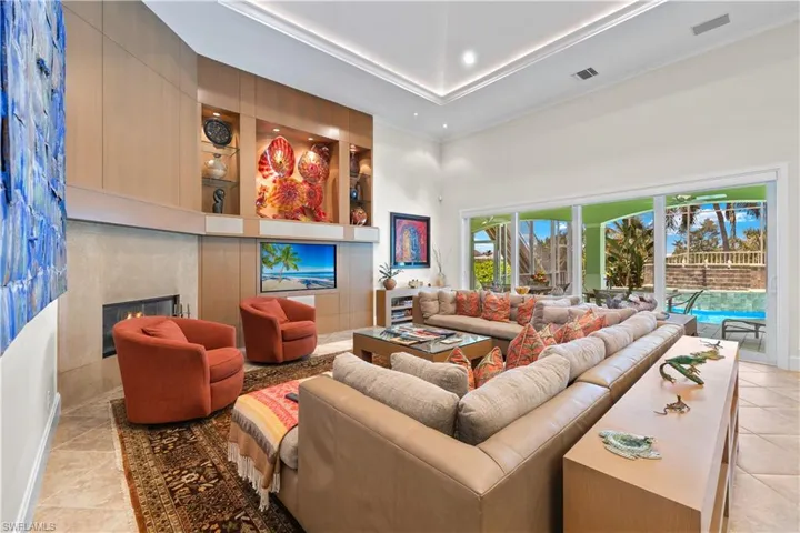Tiled living room featuring a premium fireplace and a towering ceiling