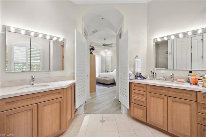 Bathroom with vanity, hardwood / wood-style floors, a shower, and ceiling fan