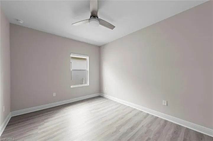 Neutral-toned walls complement wood-finish flooring in this room