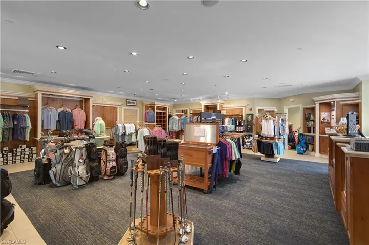 Retail interior featuring a textured carpet flooring, recessed lighting, and a neutral color palette