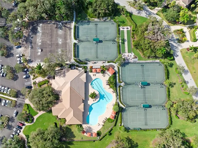 Expansive recreational grounds featuring a large swimming pool, six tennis courts, and a bocce ball court