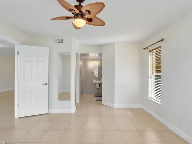 Tiled spare room with ceiling fan