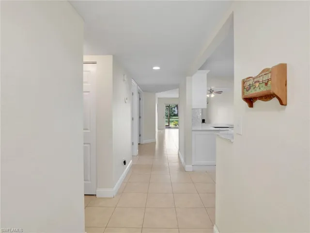 Hall featuring light tile patterned floors