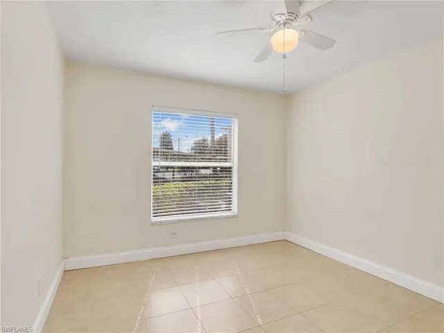 Tiled spare room with ceiling fan
