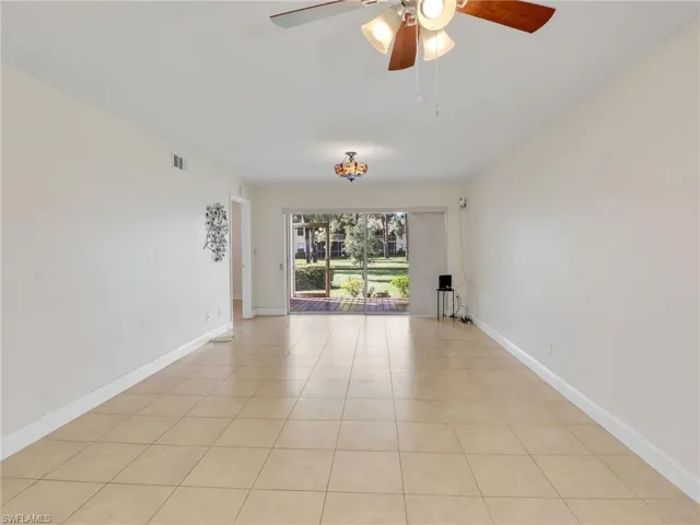Unfurnished room with ceiling fan and light tile patterned flooring