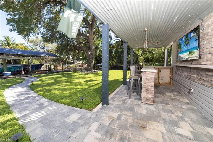 View of patio featuring a bar