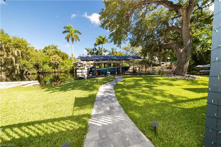 View of community with a yard and a water view