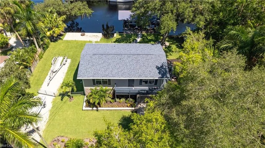 Birds eye view of property with a water view