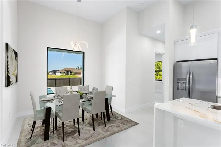 Dining area featuring recessed lighting and a chandelier