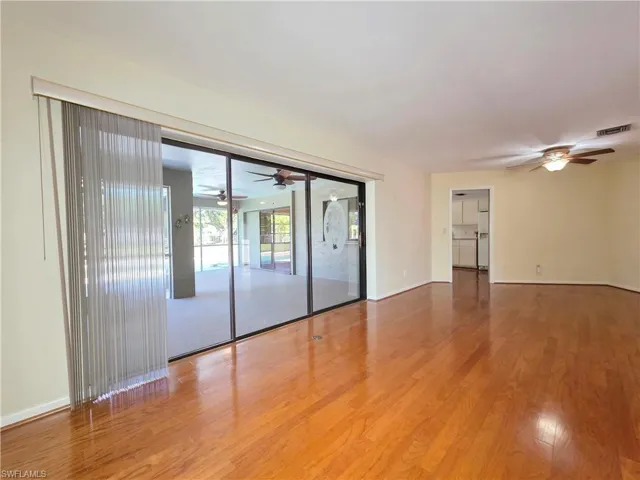 Empty room featuring ceiling fan and wood finished floors
