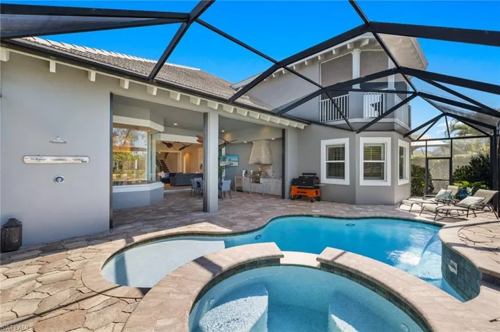 View of pool featuring a lanai, an in ground hot tub, and a patio area