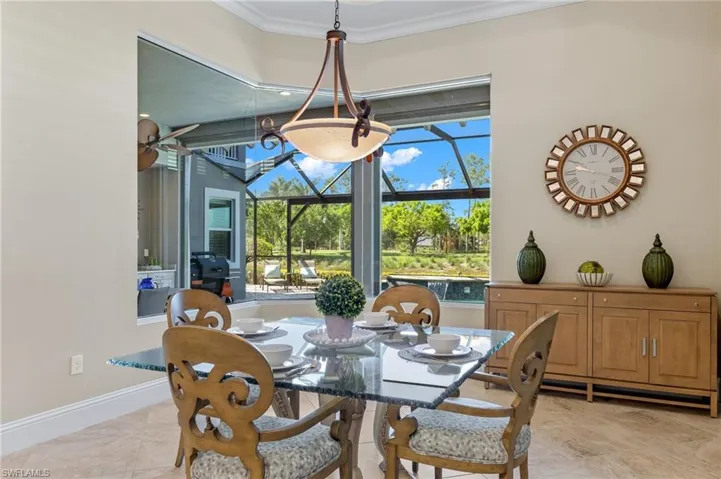 Dining space featuring ornamental molding and light tile flooring