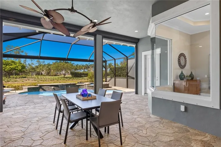 View of terrace featuring a lanai and ceiling fan