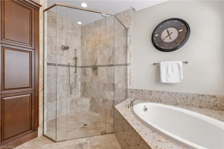 Bathroom featuring separate shower and tub and tile floors
