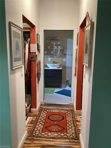 Hallway featuring sink and hardwood / wood-style floors
