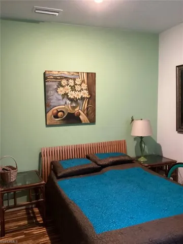 Bedroom with hardwood / wood-style flooring