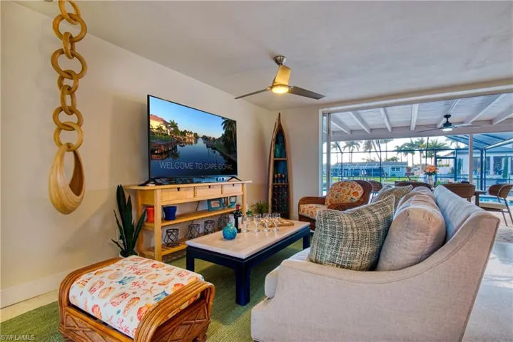 beams, carpet, and ceiling fan